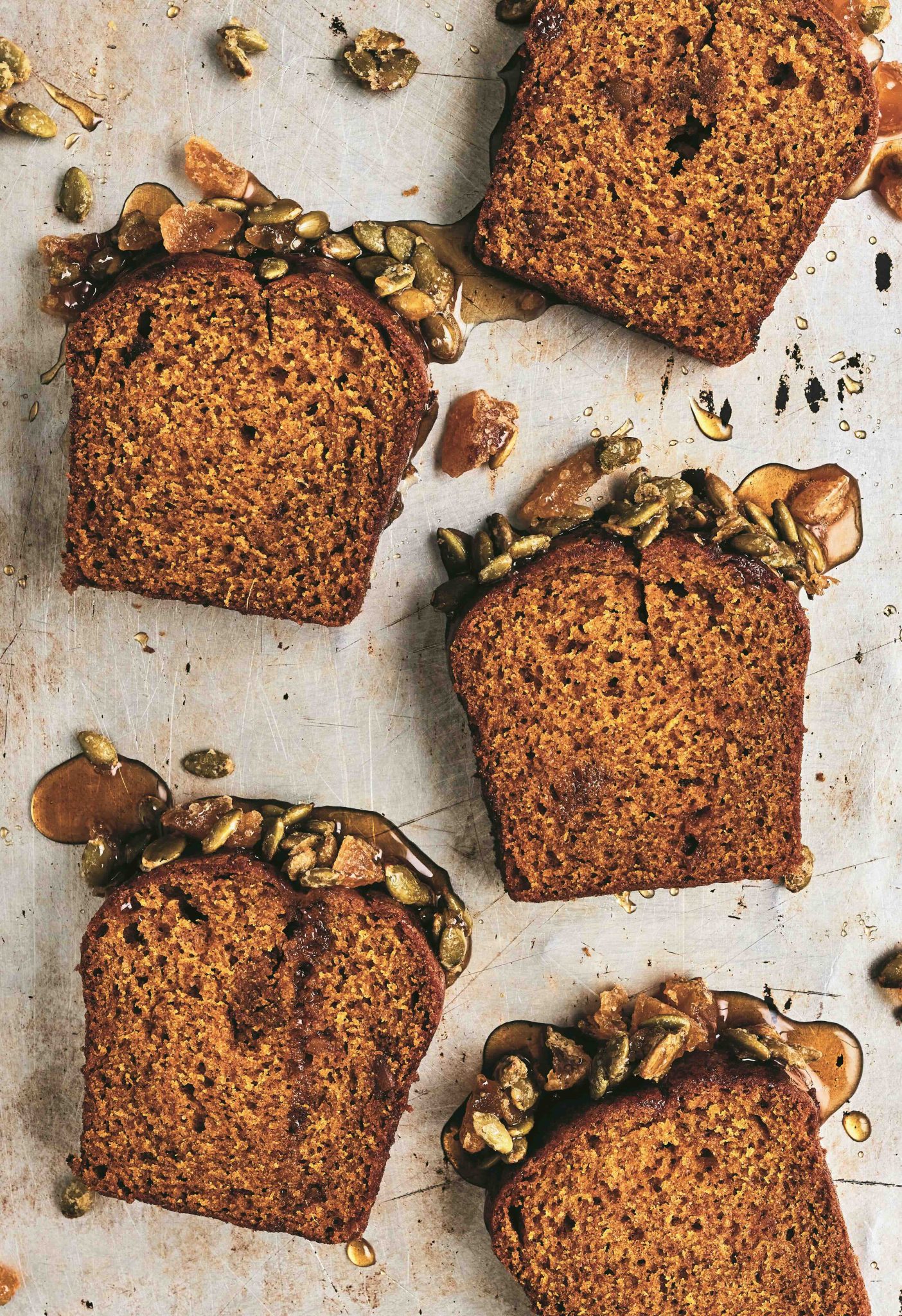 Slices of Pumpkin and Ginger Teacake with bourbon maple glaze and pumpkin seed praline 