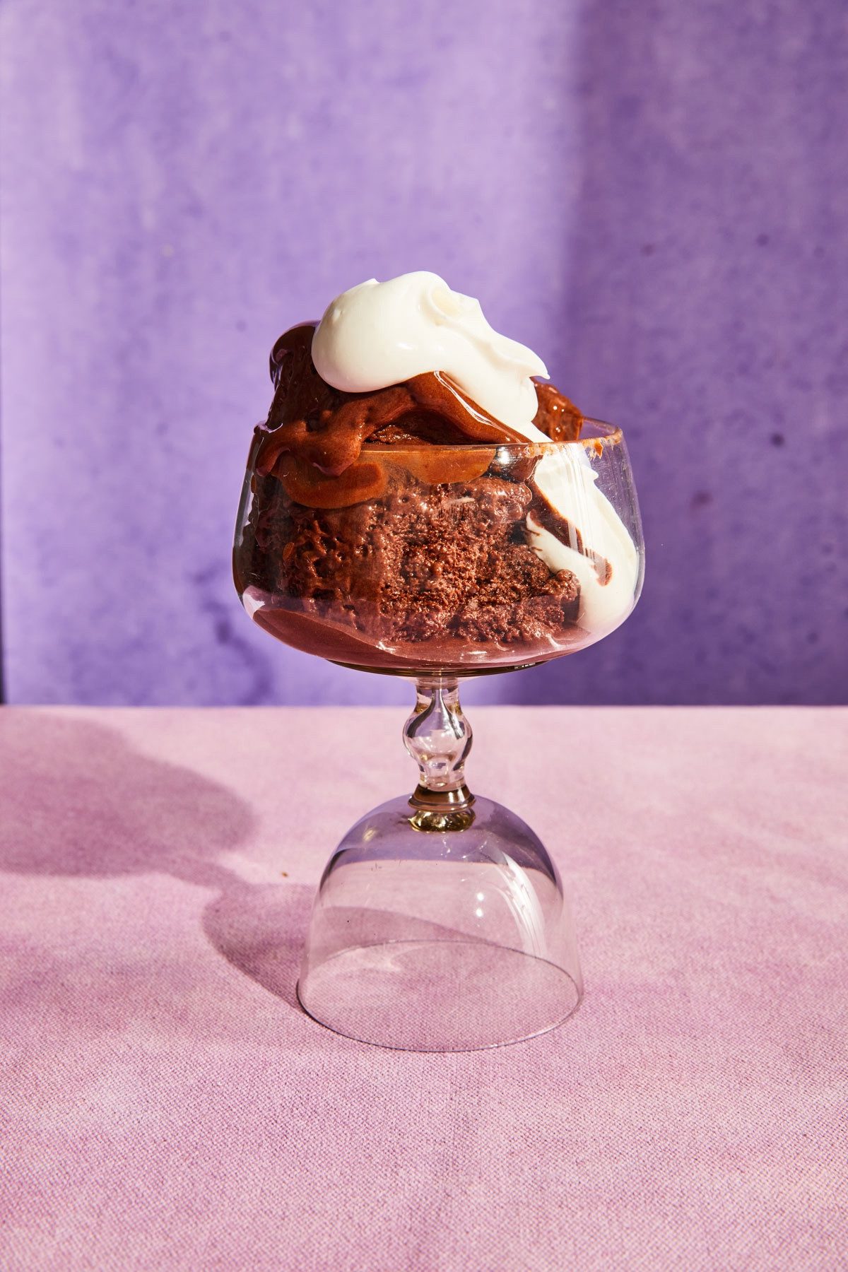 Chocolate sorbet with warm salted dates and whipped cream, served in an upside-down glass