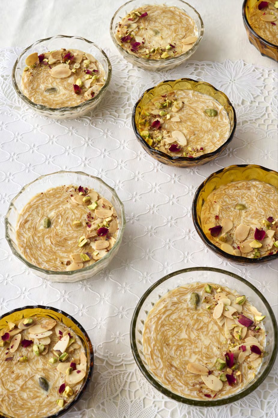 Bowls of sweetened roasted vermicelli (Seviyan) topped with almonds, pistachios, and rose petals 