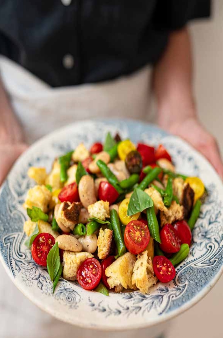 Rustic Tuscan panzanella with crispy sourdough, tomatoes, green beans, white beans and fresh basil.